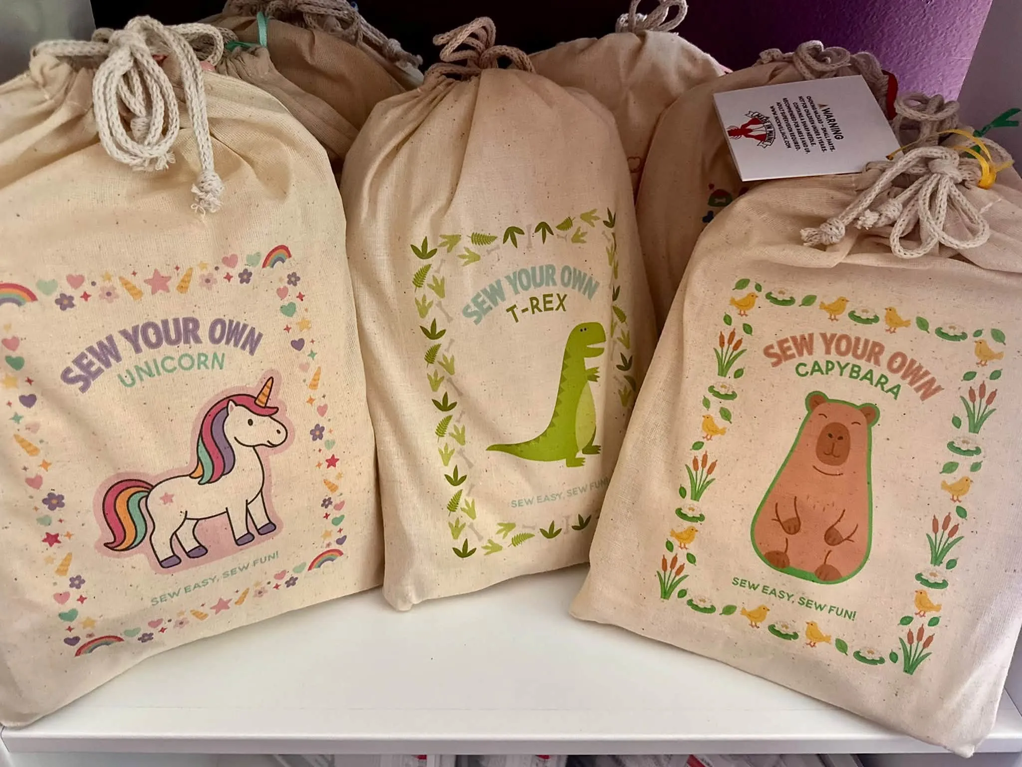 Sew-your-own craft kits on a shelf — unicorn, T-rex and capybara